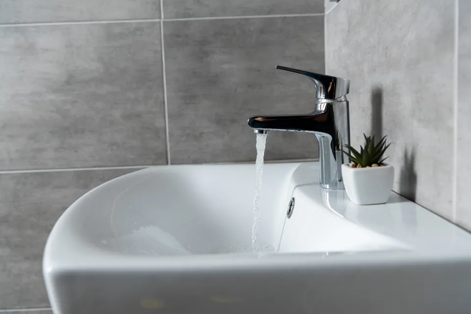 Photo of water flowing from tap into a sink